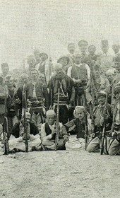 MSG057: Durrës: Group of northern fighters posing with Austrian, British and French officers, May 1914 (Marquis di San Giuliano Photo Collection).